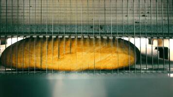 Automatic bread slicing. A device that automatically cuts bread into pieces. video