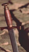 Excalibur sword in rocky stone at sunset video