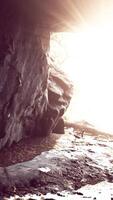 sunlight filters into a wet stone cave video