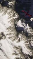 helicopter above mountains in snow video