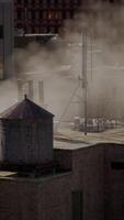 Smoke rising from a chimney on a rooftop video