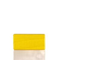 Wooden cube of yellow color on a white background photo