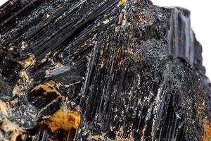 macro mineral stone sherle, schorl, black tourmaline on white background photo