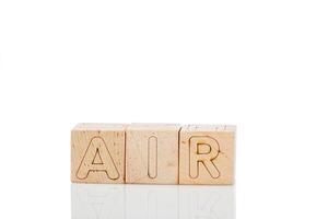 Wooden cubes with letters air on a white background photo