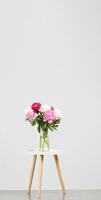 beautiful peonies in a vase on a white background photo