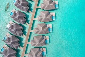 Maldives paradise scenery. Tropical aerial landscape, seascape with long jetty, water villas with amazing sea and lagoon beach, tropical nature. Exotic tourism destination banner, summer vacation photo