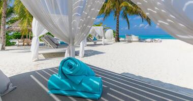 Relax on luxury VIP beach with white pavilions in sunny blue sky. Luxury vacation beach holiday in tropical resort, hotel. Couple retreat Fantastic leisure lifestyle landscape, palm trees white sand photo