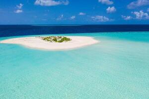 Aerial view of sandbar and blue sea. Maldivian sandbank in Indian ocean, white sandy coast crystal azure color water, perfect getaway for tropical vacations. Top aerial view, calm waves, surf relax photo