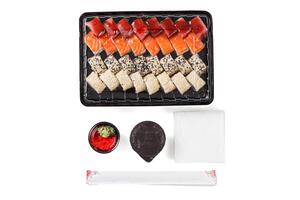 A set of sushi in a delivery box, soy sauce, chopsticks, wasabi, ginger on a white background photo