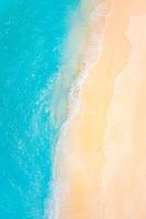 Top view on coast waves on beach aerial view, crystal clear water. Stunning summer landscape, sunny tropical island shore. Seaside, idyllic nature Earth view. Stunning scenery, amazing view photo