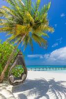 Tropical beach panorama summer relax landscape with beach swing or hammock hang on palm tree over white sand sea beachside tourism. Amazing beach vacation summer holiday coast. Luxury romantic travel photo
