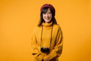 In her chic studio, a young Asian woman, wearing a yellow sweater and red beret, takes a snapshot with her camera, a joyful and artistic endeavor. photo