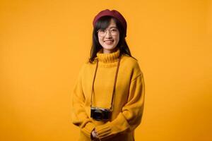 In her stylish Parisian studio, a young Asian woman, wearing a yellow sweater and red beret, creates artistic memories with her vintage camera. photo