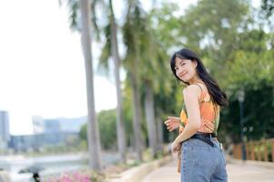 Stylish and cute lady outdoors, turning with joy, her portrait surrounded by a fashionable urban blur. photo