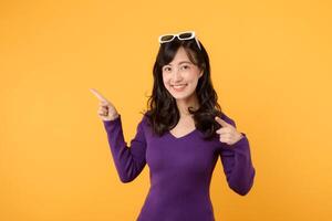 cheerful young woman wearing a purple shirt and eyeglasses, a confident businesswoman, carries success with a smile against a vibrant yellow background, symbolizing corporate success and education. photo