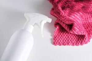 Cleaning product with a sprayer on a background of a red microfiber cloth. photo