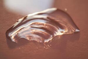 Beautiful volumetric drop of cosmetic product on a pink background. photo