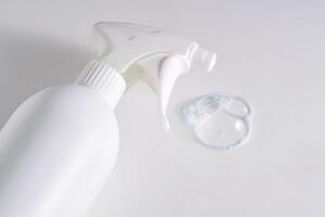 Cleaning product with a sprayer on a white background with with a sample. photo