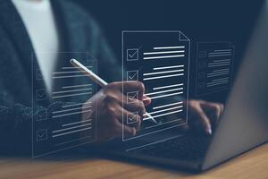Document management man signs an electronic document on digital document by virtual notebook screen using a stylus pen.E-document management Paperless workplace, e-signing, electronic signature. photo