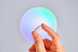 Tablet in hand against the background of a glowing circle. photo