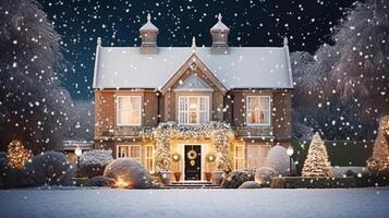 Christmas in the countryside manor, English country house mansion decorated for holidays on a snowy winter evening with snow and holiday lights, Merry Christmas and Happy Holidays photo