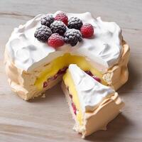 Meringue cake pudding with lemon curd sauce and berries as food, bakery and holiday baking recipe, photo