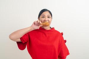 Asian woman with fried chicken on hand photo