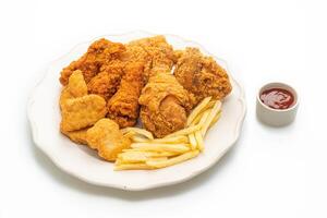 fried chicken with french fries and nuggets on white backgrpund photo