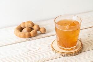 Delicious sweet drink tamarind juice and ice cube photo