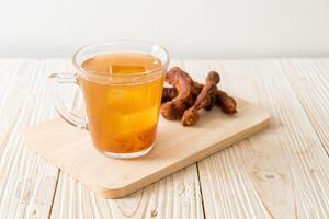 Delicious sweet drink tamarind juice and ice cube photo