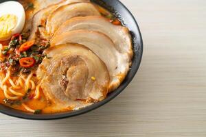 Ramen Noodles Spicy Tomyum Soup with Roast Pork photo