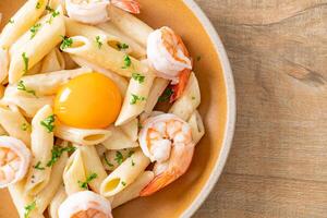 penne pasta white cream sauce with shrimps and egg photo