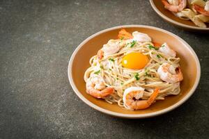 spaghetti white cream sauce with shrimps and egg yolk photo