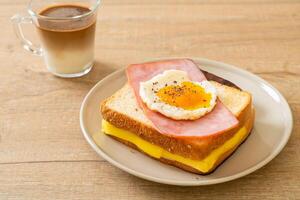 bread toasted cheese topped ham and fried egg with pork sausage photo