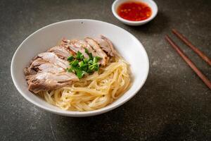 dried duck noodles in white bowl photo