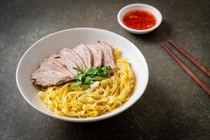 dried duck noodles in white bowl photo