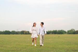 Happy young Asian couple in bride and groom clothing photo