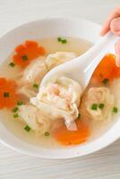 shrimp dumpling soup in white bowl photo