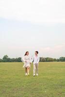 Happy young Asian couple in bride and groom clothing photo