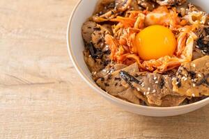 pork bulgogi rice bowl with kimchi and Korean pickled egg photo