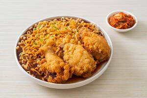 Korean instant noodles with fried chicken or Fried chicken ramyeon photo