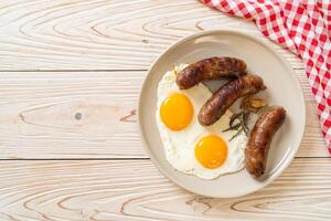 double fried egg with pork sausage photo