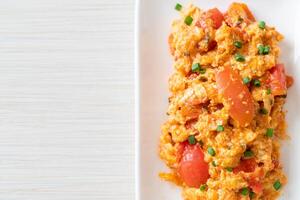 Stir-fried tomatoes with egg or Scrambled eggs with tomatoes photo