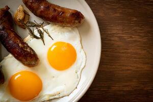 double fried egg with pork sausage photo