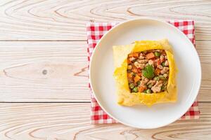 egg wrap or stuffed egg with minced pork and vegetable photo