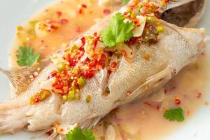 Steamed grouper fish with lime and chillies photo