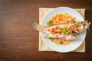 Steamed grouper fish with lime and chillies photo