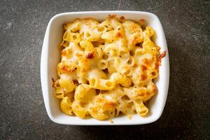 American mac and cheese, macaroni pasta in cheesy sauce photo