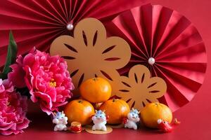 Chinese New Year of the dragon festival concept. Mandarin orange, red envelopes, dragon and gold ingot with red paper fans. Traditional holiday lunar New Year. photo