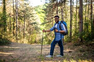 joven hombre disfruta excursionismo en naturaleza. foto